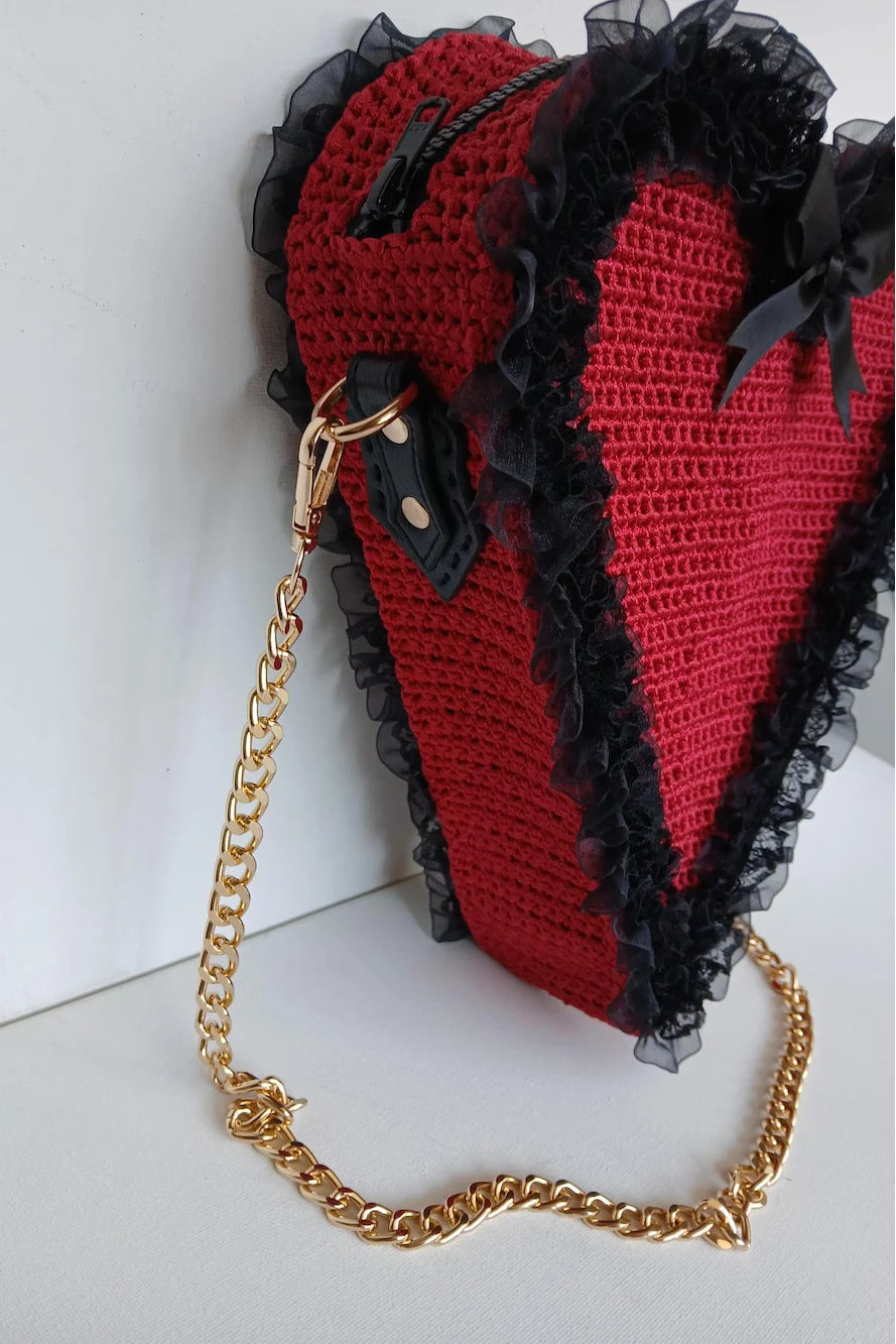 Poison Cherry Heart Bag — side detail showing gold chain strap with lobster clasp, black zipper closure and red and black crochet texture - Victorian Velvet