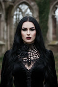 Close-up portrait of a woman with dark makeup wearing a black crochet spider web collar with black roses in gothic stone ruins - Victorian Velvet