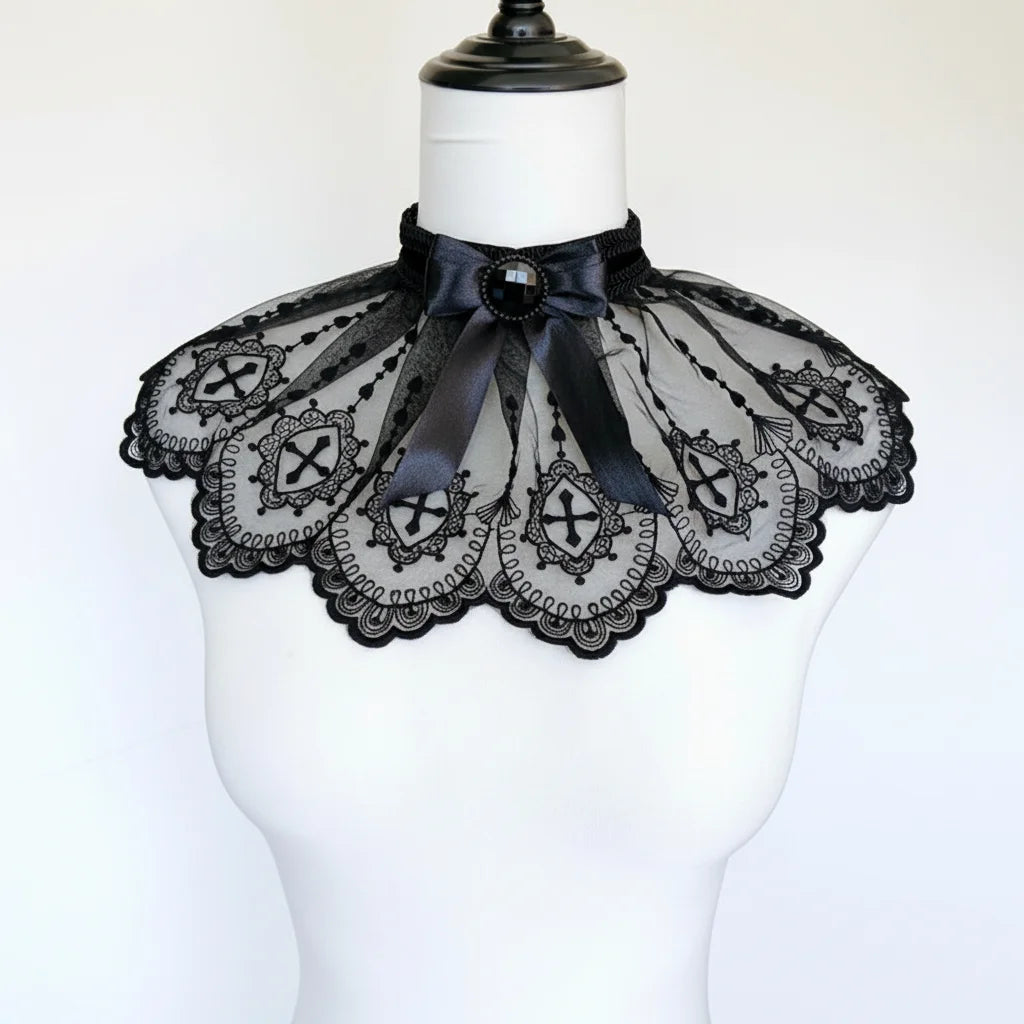 Gothic black lace collar with embroidered cross motifs, scalloped edges and black gemstone bow, displayed on mannequin, white background - Victorian Velvet