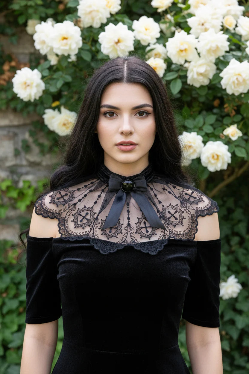 Gothic lace collar with cross embroidery and black satin bow, worn by a dark-haired woman in a black velvet dress, white rose garden background - Victorian Velvet