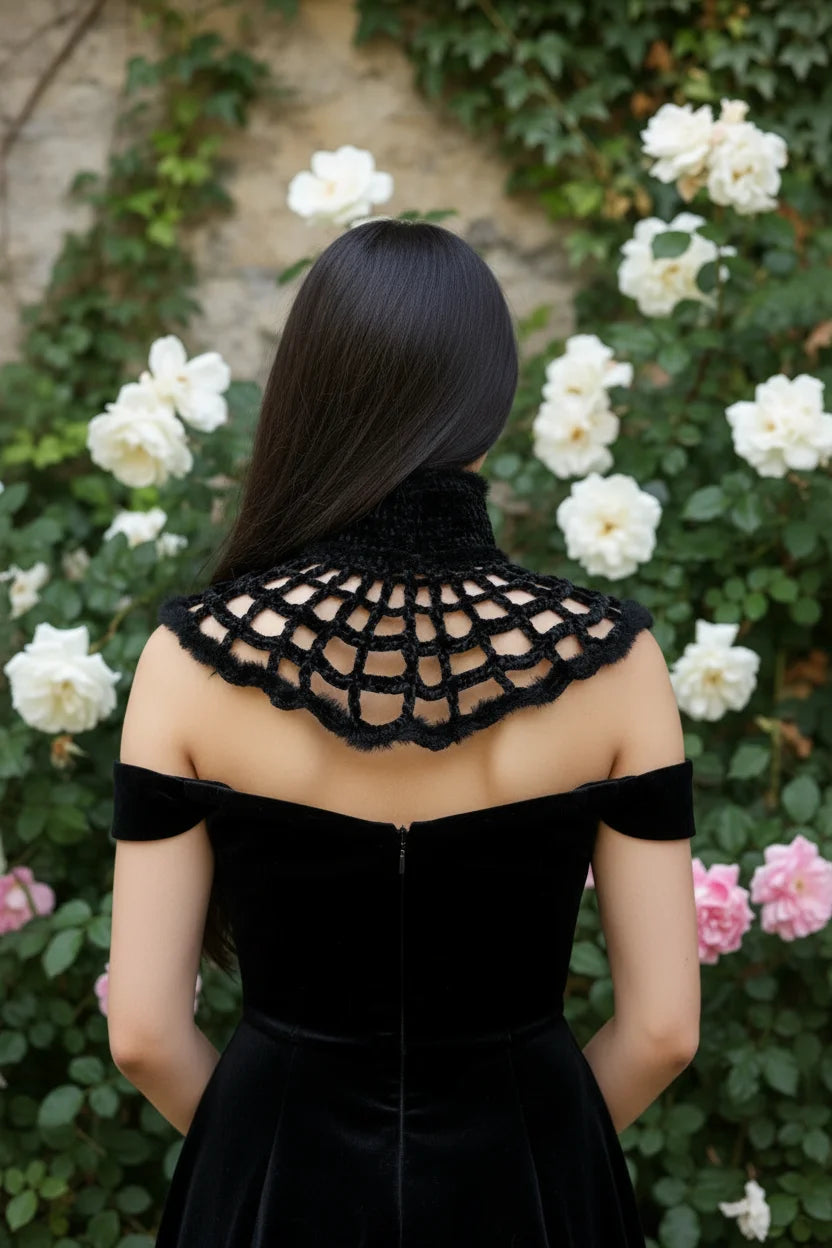 Back view of black fluffy velvet spiderweb crochet collar spreading across shoulders, dark-haired woman in black off-shoulder velvet dress, white rose garden - Victorian Velvet