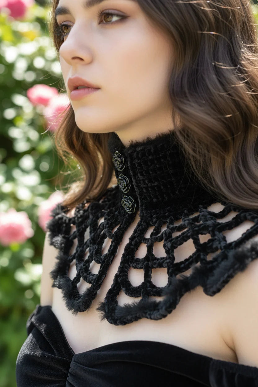 Close-up side view of black fluffy velvet spiderweb crochet collar with rose-shaped buttons and ribbon tie, worn with black velvet dress, pink roses in background - Victorian Velvet