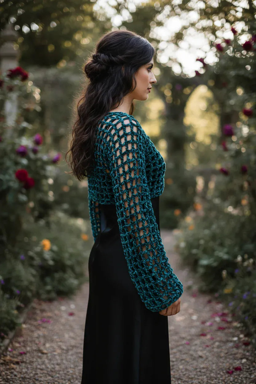 Side view of forest green velvet crochet mesh sweater with open geometric pattern worn in a romantic rose garden at dusk - Victorian Velvet
