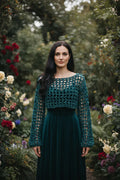 Woman wearing forest green velvet crochet mesh sweater with wide boat neckline standing in a blooming rose garden - Victorian Velvet
