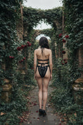 Handmade black crochet lingerie set, back view on model, romantic gothic garden ruins with ivy arches and dark red roses - Victorian Velvet