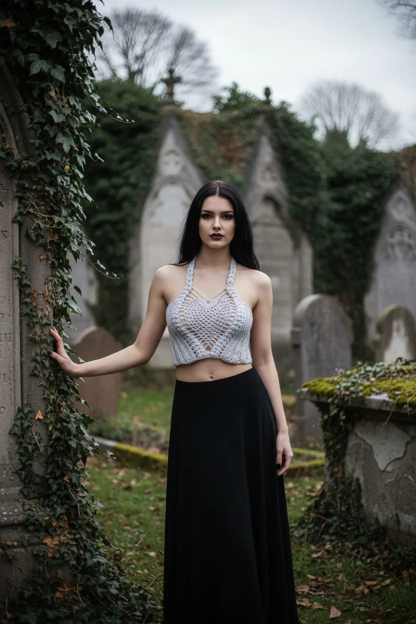 Moonlight Halter Top Silver — handmade silver crochet halter crop top, front view, gothic cemetery setting with ivy and stone monuments - Victorian Velvet