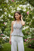 Moonlight Peplum Top Silver — handmade silver crochet peplum halter top, front view, romantic garden with blooming roses, white wide-leg trousers - Victorian Velvet