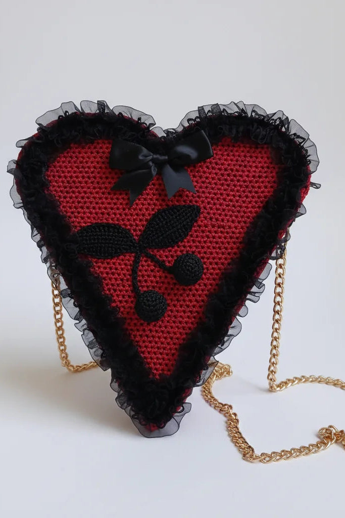 Poison Cherry Heart Bag — front view with black crocheted cherry appliqué, black satin bow, black lace ruffle trim and gold chain strap attached to both sides - Victorian Velvet