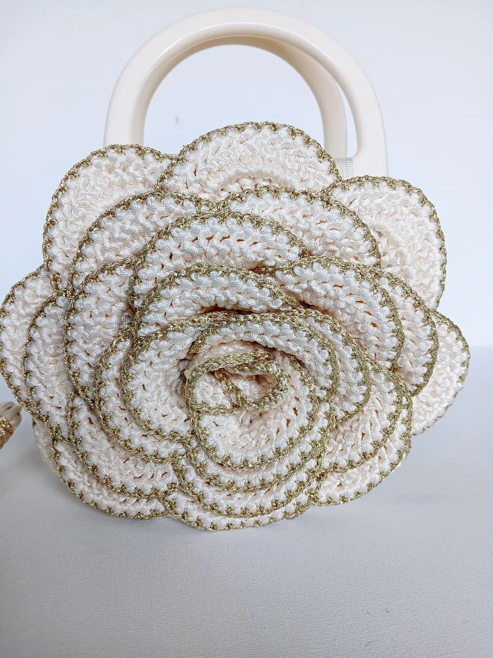 Versailles Rose handmade crochet rose handbag close up detail of cream and gold metallic yarn petals with intricate crochet texture — Victorian Velvet
