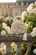 Versailles Rose handmade crochet rose handbag on stone balustrade in romantic white rose garden — Victorian Velvet